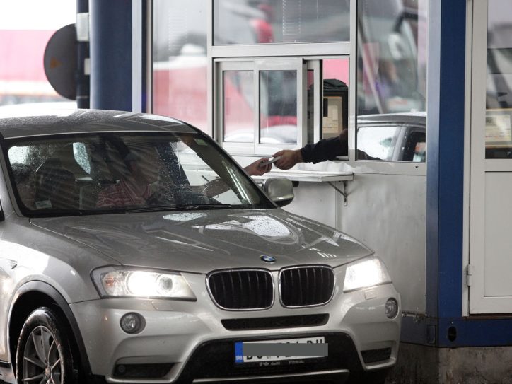 Automobil na granici, vozač pruža pasoš graničaru